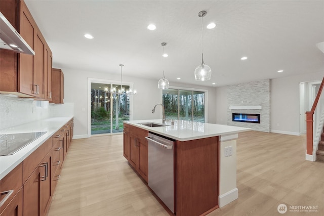 13600 100th St NE Unit 212, Lake Stevens, WA 98258 - kitchen with stainless steel dishwasher, exhaust hood, black electric cooktop, light wood-style flooring, and recessed lighting