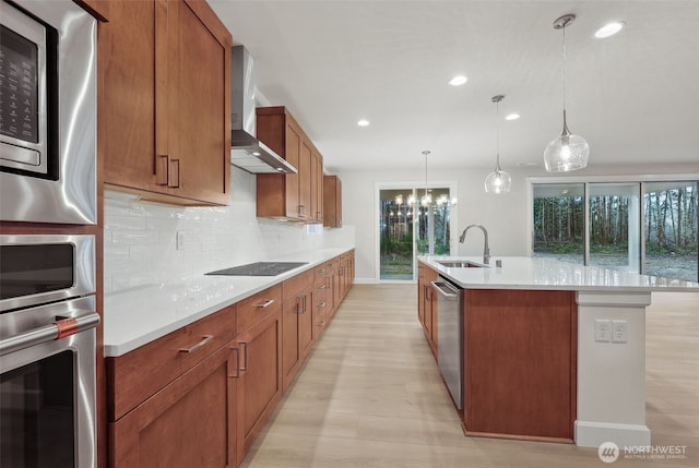13600 100th St NE Unit 212, Lake Stevens, WA 98258 - kitchen featuring wall chimney exhaust hood, appliances with stainless steel finishes, healthy amount of natural light, tasteful backsplash, and recessed lighting