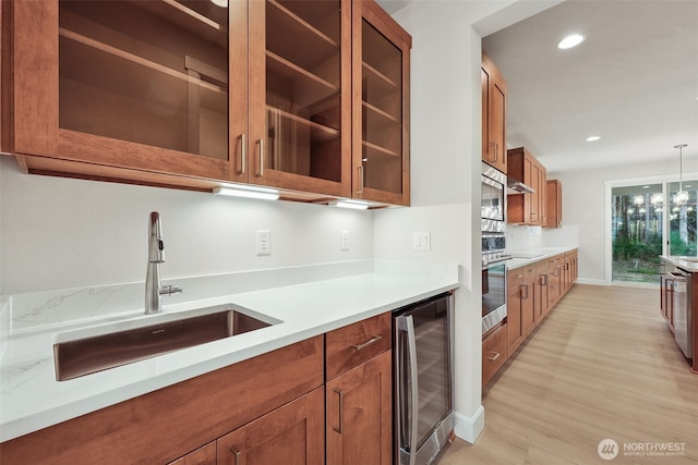 13600 100th St NE Unit 212, Lake Stevens, WA 98258 - kitchen with beverage cooler, brown cabinets, light wood-style floors, light countertops, and glass insert cabinets