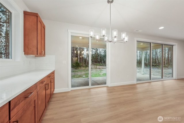 13600 100th St NE Unit 212, Lake Stevens, WA 98258 - unfurnished dining area featuring a chandelier, light wood-type flooring, healthy amount of natural light, and recessed lighting