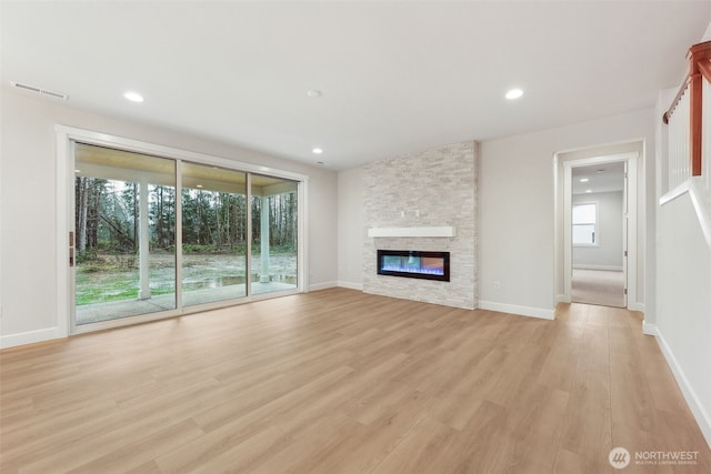 13600 100th St NE Unit 212, Lake Stevens, WA 98258 - unfurnished living room featuring light wood-type flooring, a stone fireplace, and recessed lighting