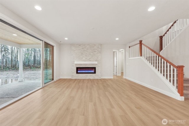 13600 100th St NE Unit 212, Lake Stevens, WA 98258 - unfurnished living room with light wood finished floors, recessed lighting, stairs, and a fireplace