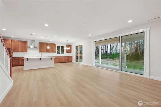 13600 100th St NE Unit 212, Lake Stevens, WA 98258 - unfurnished living room featuring light wood-style flooring, recessed lighting, and stairs