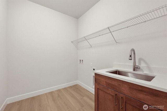 13600 100th St NE Unit 212, Lake Stevens, WA 98258 - washroom with electric dryer hookup, hookup for a washing machine, light wood finished floors, and cabinet space