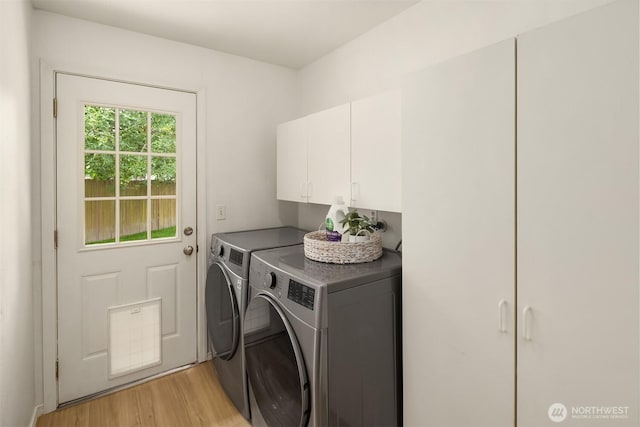 15484 174th Ave SE, Monroe, WA 98272 - washroom with washer and clothes dryer, cabinet space, and light wood-style floors