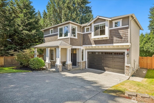 6555 125th Ave NE, Kirkland, WA 98033 - view of front of home with asphalt driveway, stone siding, and an attached garage
