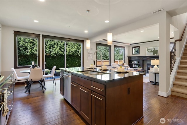 6555 125th Ave NE, Kirkland, WA 98033 - kitchen with stainless steel dishwasher, a fireplace, dark wood finished floors, decorative light fixtures, and open floor plan