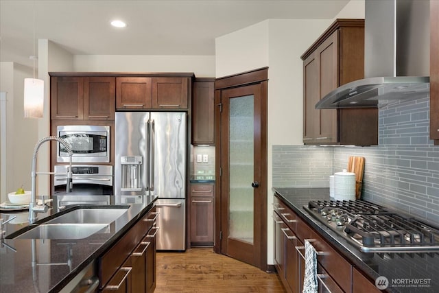 6555 125th Ave NE, Kirkland, WA 98033 - kitchen with stainless steel appliances, wall chimney exhaust hood, dark stone countertops, light wood-type flooring, and backsplash