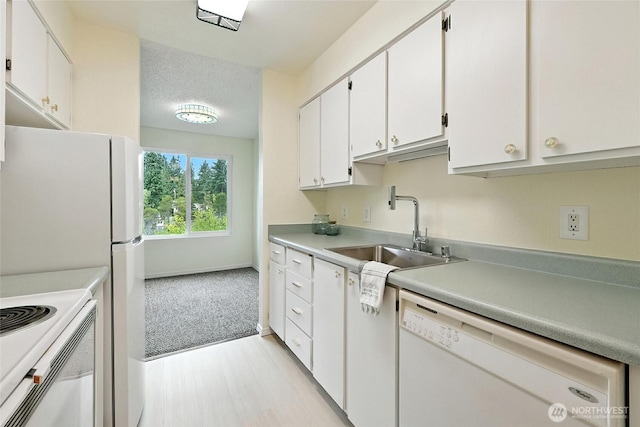 615 75th St SE Unit C43, Everett, WA 98203 - kitchen featuring white appliances, white cabinets, light countertops, and light wood-style flooring