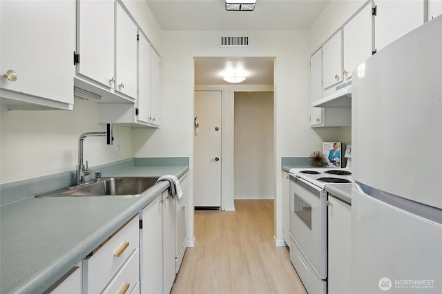 615 75th St SE Unit C43, Everett, WA 98203 - kitchen with white appliances, under cabinet range hood, light wood finished floors, white cabinets, and light countertops