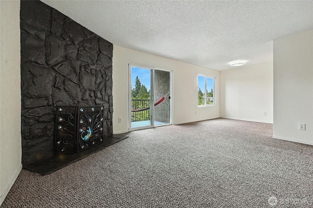 615 75th St SE Unit C43, Everett, WA 98203 - unfurnished living room with carpet flooring, a textured ceiling, and a stone fireplace
