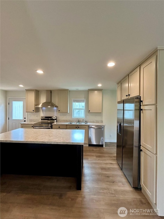 40 E Skywater Pl, Shelton, WA 98584 - kitchen with wall chimney exhaust hood, stainless steel appliances, light countertops, light wood-style flooring, and healthy amount of natural light