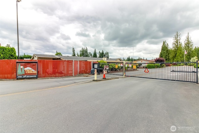 37301 28th Ave S Unit 34, Federal Way, WA 98003 - view of asphalt street featuring a gate, curbs, and a gated entry