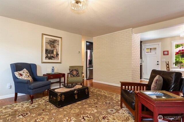 7923 220th St SW, Edmonds, WA 98026 - living area featuring wood finished floors and brick wall