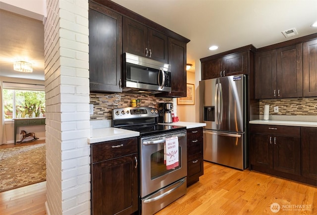 7923 220th St SW, Edmonds, WA 98026 - kitchen with appliances with stainless steel finishes, light wood-type flooring, light countertops, decorative backsplash, and recessed lighting