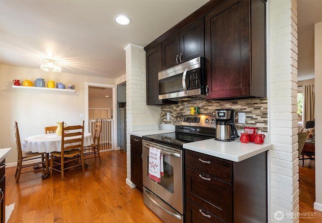 7923 220th St SW, Edmonds, WA 98026 - kitchen with appliances with stainless steel finishes, light countertops, backsplash, light wood finished floors, and recessed lighting