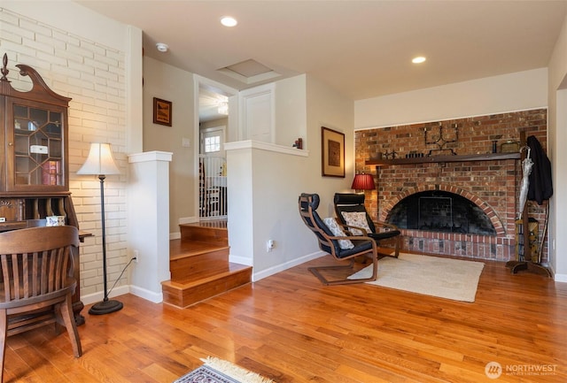 7923 220th St SW, Edmonds, WA 98026 - living area featuring wood finished floors, a brick fireplace, stairway, and recessed lighting