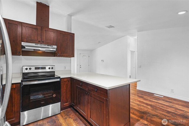 20102 119th St E, Sumner, WA 98390 - kitchen featuring appliances with stainless steel finishes, under cabinet range hood, dark wood-type flooring, a peninsula, and recessed lighting