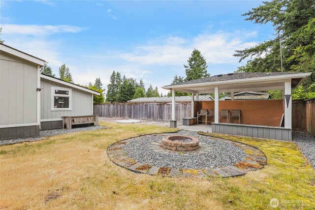 20102 119th St E, Sumner, WA 98390 - fenced backyard featuring an outdoor fire pit and a gazebo