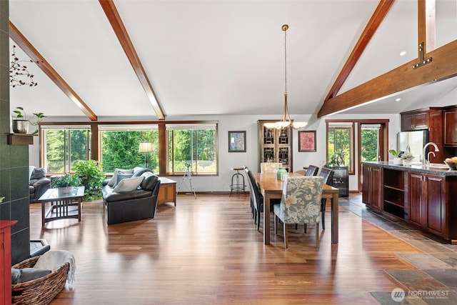 931 SW Moose Hill Ct, Port Orchard, WA 98367 - dining area with a chandelier, beam ceiling, healthy amount of natural light, wood finished floors, and high vaulted ceiling