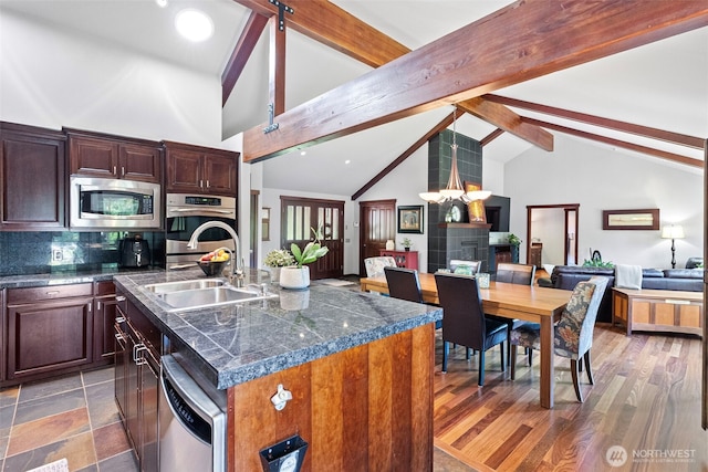 931 SW Moose Hill Ct, Port Orchard, WA 98367 - kitchen with appliances with stainless steel finishes, open floor plan, a center island with sink, beamed ceiling, and backsplash