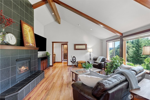 931 SW Moose Hill Ct, Port Orchard, WA 98367 - living room featuring beamed ceiling, a tile fireplace, light wood-type flooring, and high vaulted ceiling