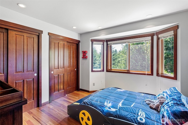 931 SW Moose Hill Ct, Port Orchard, WA 98367 - bedroom featuring light wood-type flooring, recessed lighting, and two closets