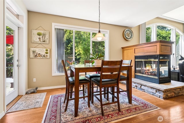8206 66th Avenue Ct E, Puyallup, WA 98371 - dining area with healthy amount of natural light, a stone fireplace, and light wood-type flooring