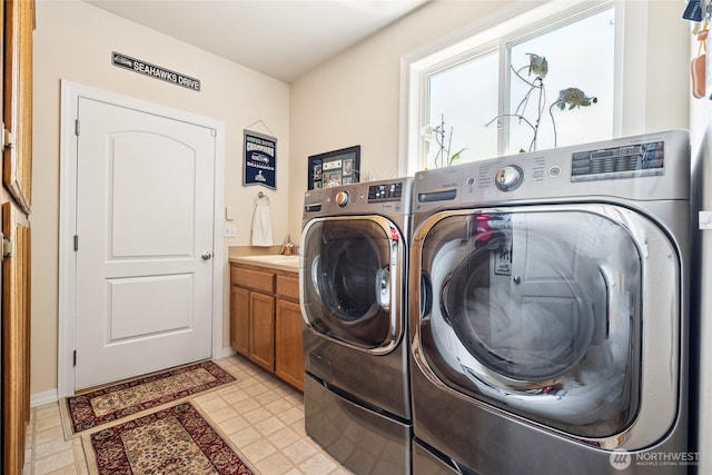 8206 66th Avenue Ct E, Puyallup, WA 98371 - washroom featuring washing machine and dryer and cabinet space