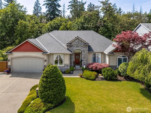 8206 66th Avenue Ct E, Puyallup, WA 98371 - craftsman-style home featuring stone siding, a garage, concrete driveway, a shingled roof, and a front lawn