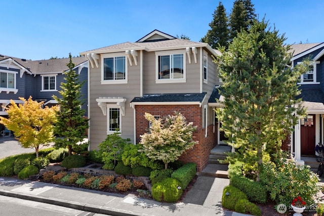 3913 W Briarcliff Ln, Seattle, WA 98199 - view of front facade featuring brick siding and roof with shingles