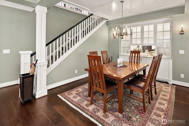3913 W Briarcliff Ln, Seattle, WA 98199 - dining space with decorative columns, hardwood / wood-style floors, a chandelier, and stairs