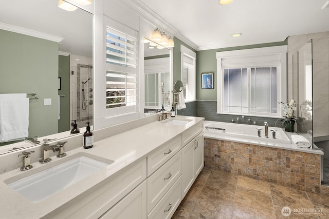 3913 W Briarcliff Ln, Seattle, WA 98199 - bathroom featuring crown molding, double vanity, a bath, a tile shower, and recessed lighting