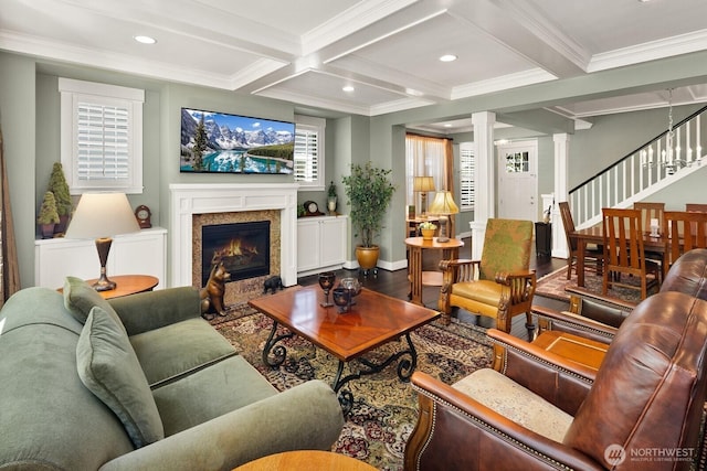 3913 W Briarcliff Ln, Seattle, WA 98199 - living room featuring beam ceiling, crown molding, coffered ceiling, a fireplace with flush hearth, and wood finished floors