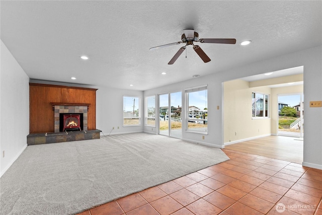 4126 Matia Dr, Ferndale, WA 98248 - unfurnished living room featuring recessed lighting, light tile patterned floors, ceiling fan, a tiled fireplace, and a textured ceiling