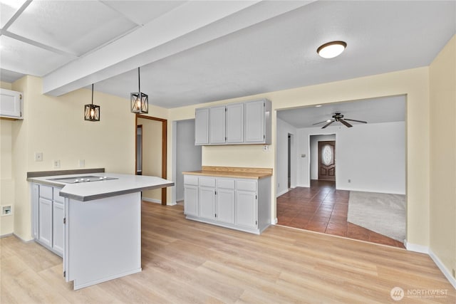 4126 Matia Dr, Ferndale, WA 98248 - kitchen featuring a peninsula, black electric stovetop, ceiling fan, light countertops, and decorative light fixtures