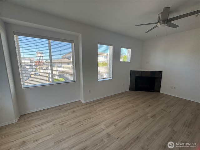 14915 38th Dr SE Unit Ii2051, Bothell, WA 98012 - unfurnished living room with a tile fireplace, wood finished floors, and ceiling fan