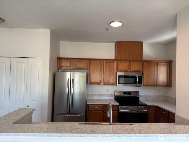 14915 38th Dr SE Unit Ii2051, Bothell, WA 98012 - kitchen featuring stainless steel appliances and brown cabinetry