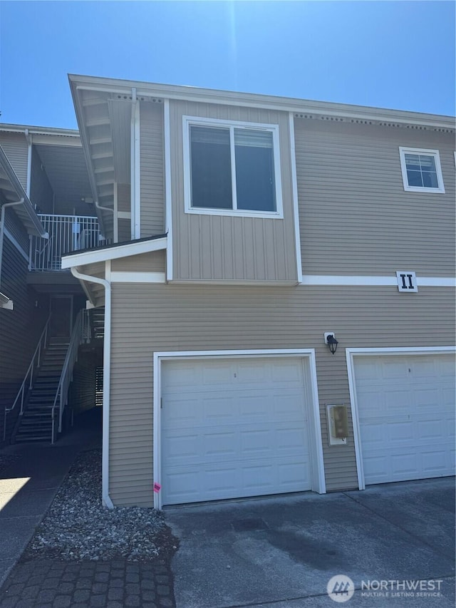 14915 38th Dr SE Unit Ii2051, Bothell, WA 98012 - rear view of property with an attached garage, stairway, asphalt driveway, and a balcony