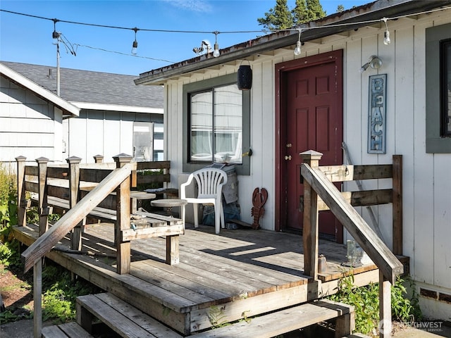 1205 49th St, Seaview, WA 98644 - view of exterior entry with a deck and a shingled roof