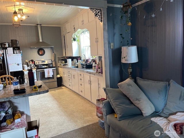 1205 49th St, Seaview, WA 98644 - kitchen featuring electric stove, wall chimney exhaust hood, light countertops, light floors, and white cabinets