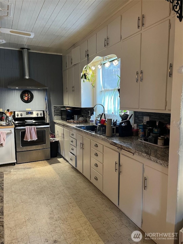 1205 49th St, Seaview, WA 98644 - kitchen featuring stainless steel electric range, wall chimney exhaust hood, light floors, and wooden ceiling