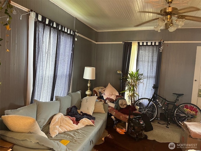 1205 49th St, Seaview, WA 98644 - living room with carpet, ceiling fan, and wooden walls