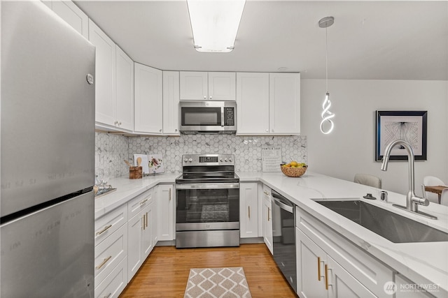 6347 137th Ave NE Unit 262, Redmond, WA 98052 - kitchen featuring stainless steel appliances, white cabinetry, light stone countertops, and tasteful backsplash