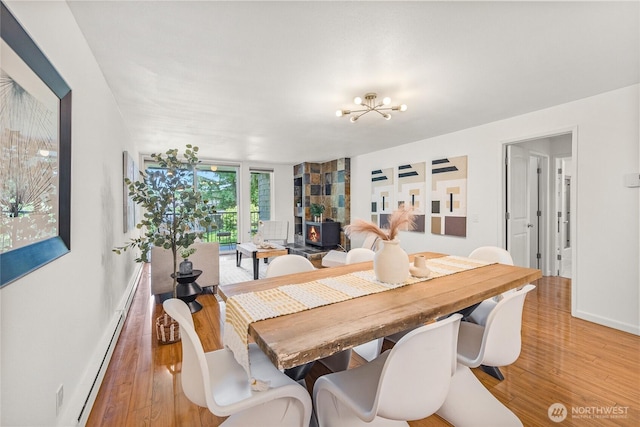 6347 137th Ave NE Unit 262, Redmond, WA 98052 - dining area with a chandelier, light wood finished floors, and baseboard heating