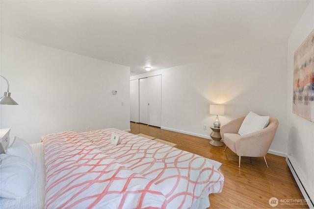 6347 137th Ave NE Unit 262, Redmond, WA 98052 - bedroom with a baseboard heating unit, wood finished floors, and a closet