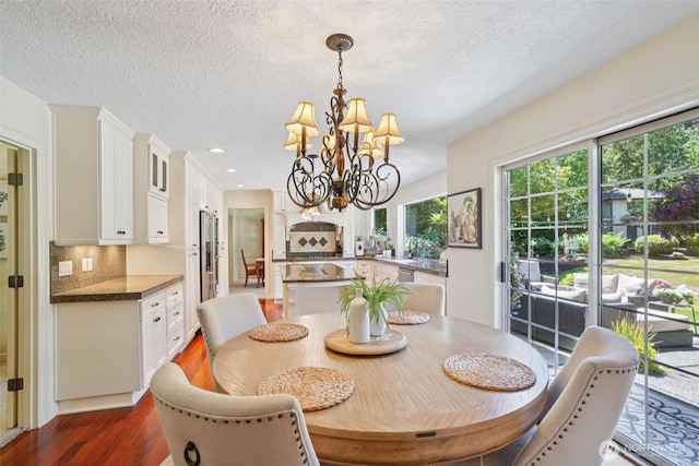 1800 SE 202nd Ave, Camas, WA 98607 - dining space featuring dark wood-type flooring, a chandelier, a textured ceiling, and recessed lighting