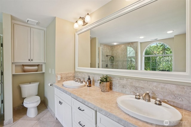 1800 SE 202nd Ave, Camas, WA 98607 - bathroom with a tile shower, double vanity, tile patterned flooring, and decorative backsplash