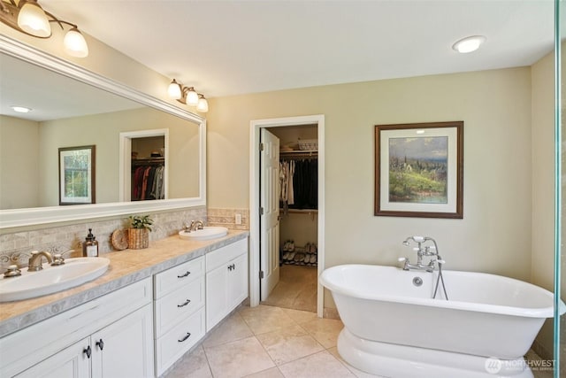 1800 SE 202nd Ave, Camas, WA 98607 - full bathroom with double vanity, a freestanding bath, a walk in closet, tile patterned flooring, and decorative backsplash