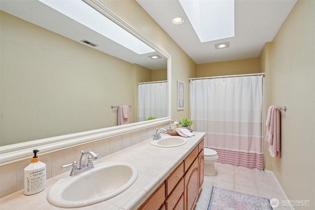 1800 SE 202nd Ave, Camas, WA 98607 - full bathroom featuring a skylight, double vanity, tile patterned flooring, recessed lighting, and a shower with curtain